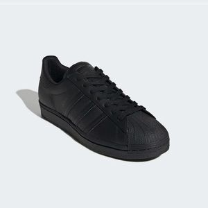 Adidas: Black Superstar Sneakers